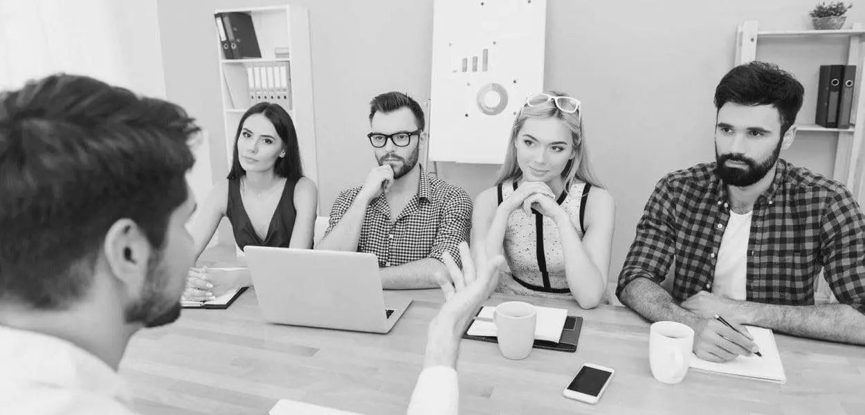 several younger professionals in casual clothes at a business meeting