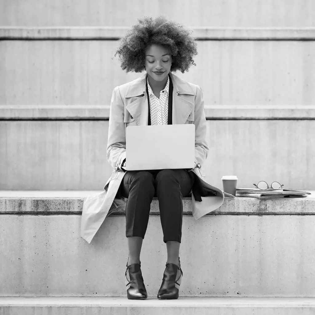 Person outdoors working on a laptop