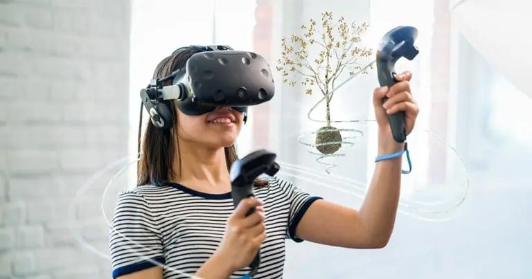 a young girl wearing a VR headset and holding two VR controllers with a digital image of a growing tree floating in front of her to symbolize gamification in education