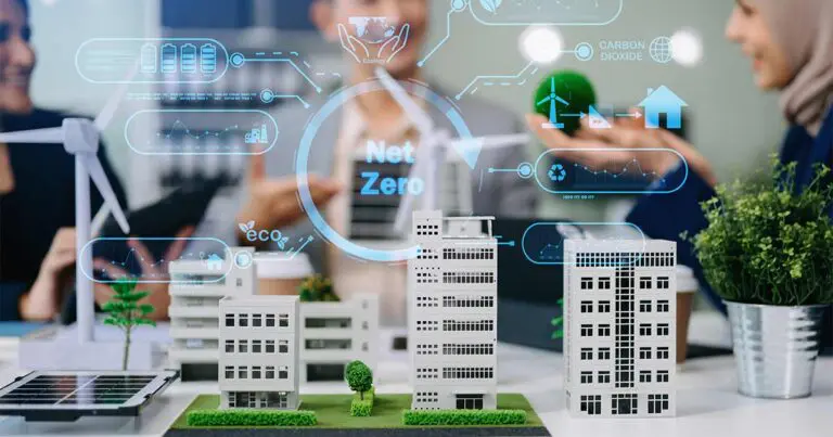 Alt text: "A digitally enhanced image showcasing sustainable urban planning concepts, with miniature models of buildings, wind turbines, and solar panels displayed on a desk. Holographic-style icons and graphs representing digital twins. In the background, blurred individuals collaborate, highlighting innovative workplace planning.