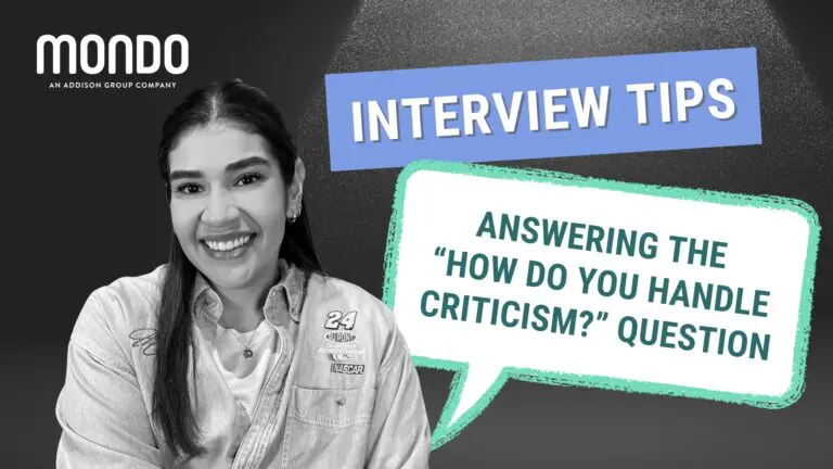 Black and white image of a female professional with purple and green speech bubbles next to her that read "Interview Tips - Answering the 'How do you handle criticism?' question"