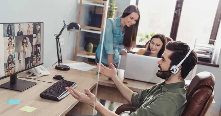 Hybrid team collaborating through video conferencing and in-office support, representing how to promote career building in your company by integrating remote and on-site talent.