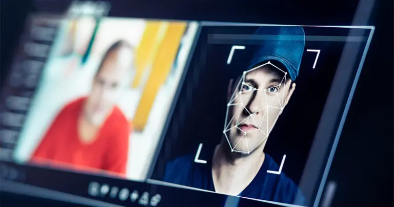 A computer screen shows two faces: on the left, a blurred person in a red shirt; on the right, a clearer image of a man wearing a baseball cap, overlaid with digital facial recognition lines and square markers. The interface suggests the use of facial analysis or identity verification software.