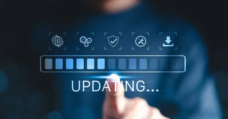 A person’s finger touches a glowing digital progress bar labeled “UPDATING…” on a dark blue background, surrounded by icons representing internet connectivity, security, tools, and downloads. The image conveys a sense of technology, progress, and system updates.