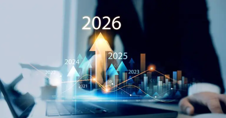 A business professional works on a laptop as translucent charts and upward arrows labeled 2021 through 2026 rise across the screen, with 2026 highlighted at the center. The glowing graphs and data lines suggest accelerating growth, forecasting, and future-focused financial planning.