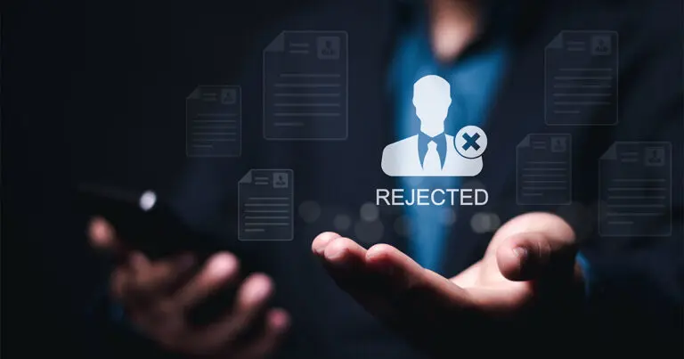 A man in a suit with a blue tie with his hands outstretched standing in a dark background with a digital overlay of candidate resumes and profiles with one larger at the forefront marked "rejected" to symbolize the death of resumes