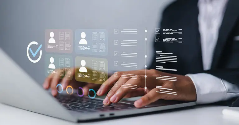 A business professional types on a laptop beneath a digital overlay showing employee profiles, checklists, documents, and assessment indicators. The interface suggests evaluating an organization’s readiness for adopting AI.