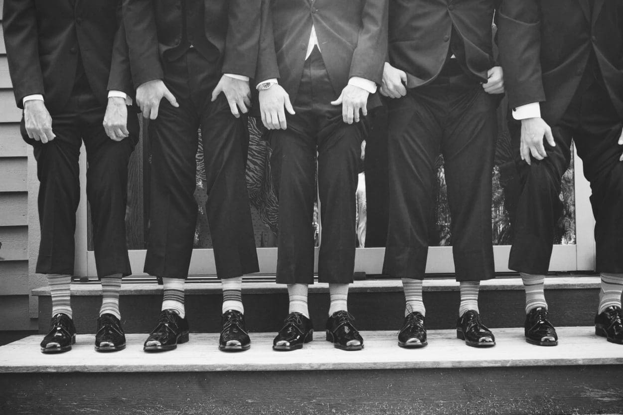 vintage photo of men in business suites exposing their dress socks