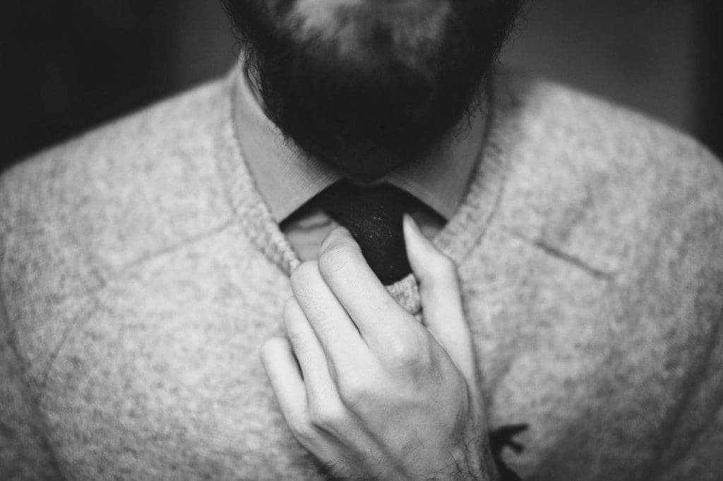 closeup of a person adjusting their tie