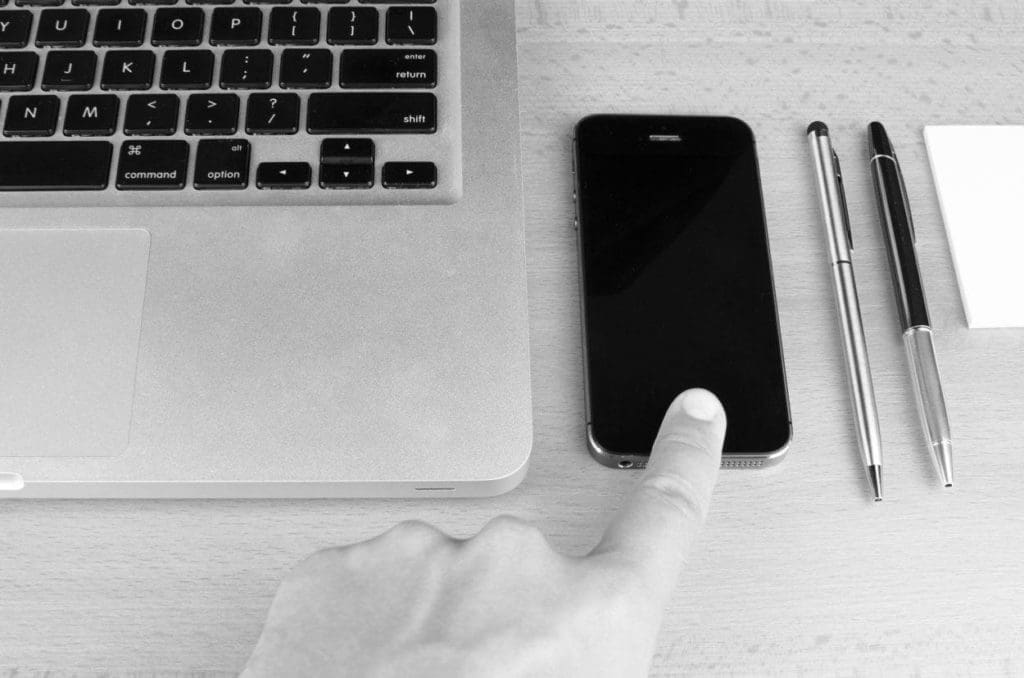 laptop smartphone pens on a desk