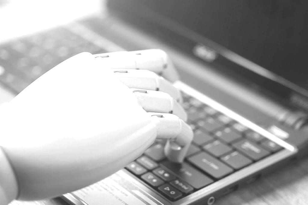 an abstract robotic arm on top of a laptop keyboard
