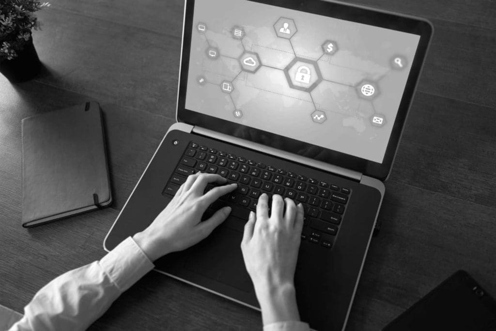 Top view of a person working on a laptop with a blockchain graphic