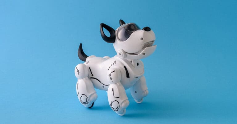 image of a black and white colored robotic dog against a light blue background